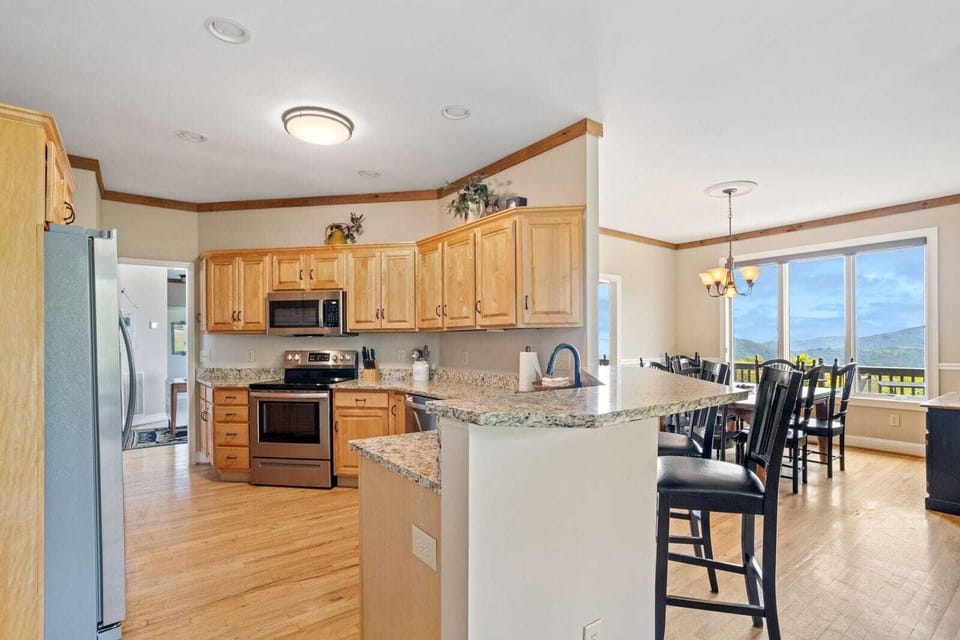 Spacious Kitchen with Bar Seating Adjacent to the Dining Area