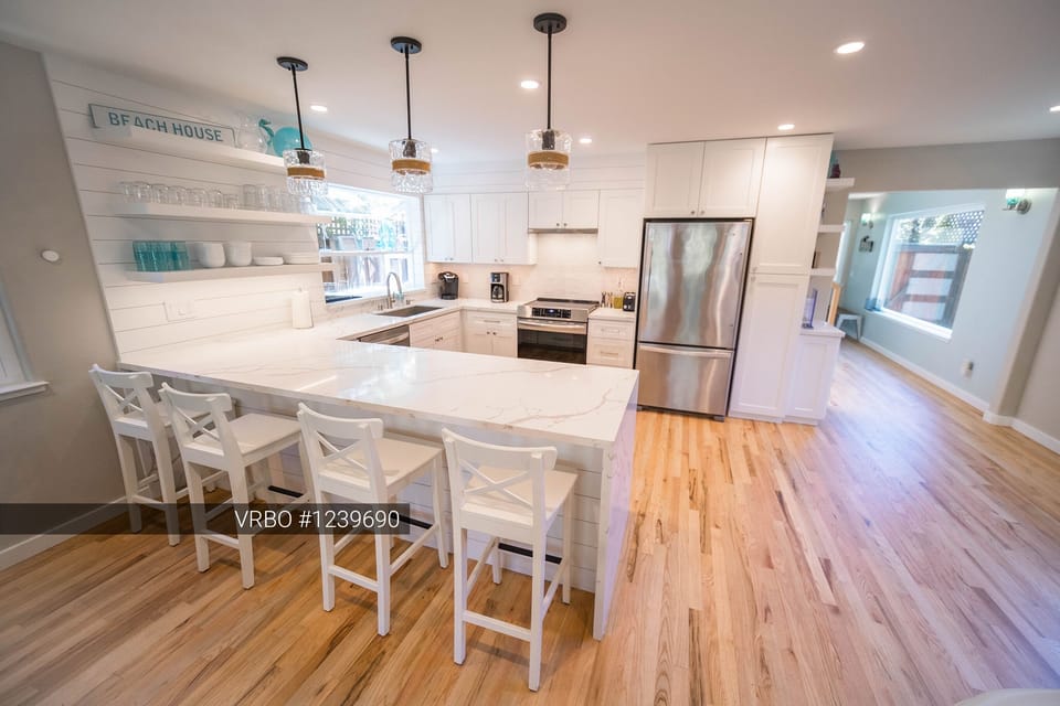 New, well-stock kitchen seats four at the island and has plenty of room to cook.