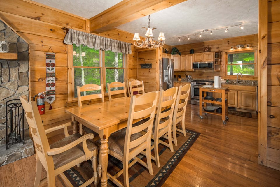 Open dining area with seating for eight and easy access to the kitchen and living room