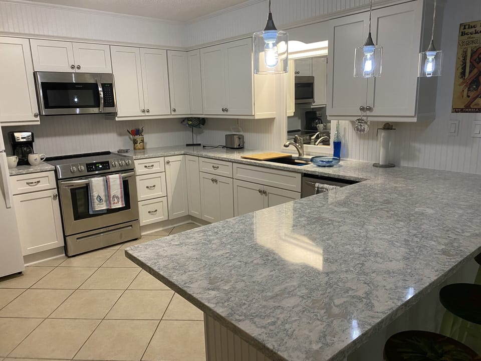 new kitchen with designer cabinets, quartz counter stainless steel appliances 