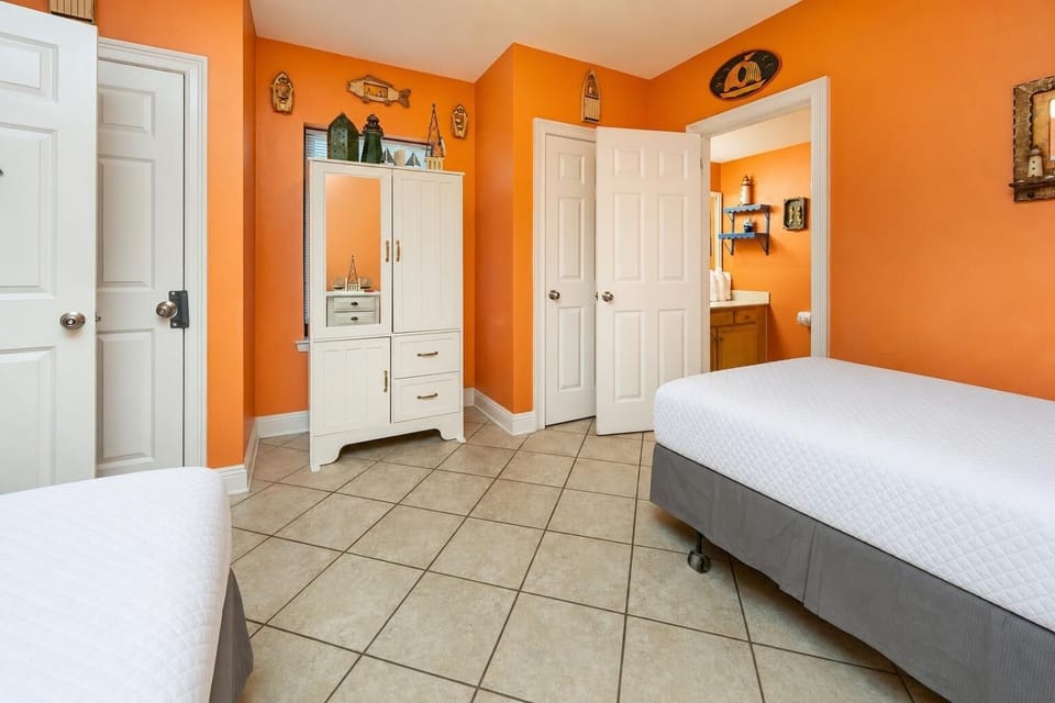 Bright orange walls surround the guest suite where you rest after a day of coastal adventures