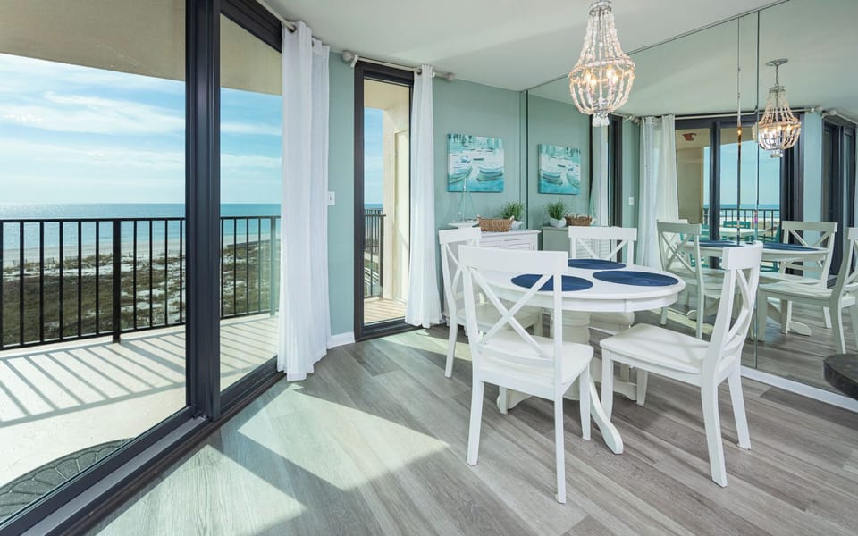 Dine at the round table while enjoying expansive views through the floor-to-ceiling windows and soft natural light