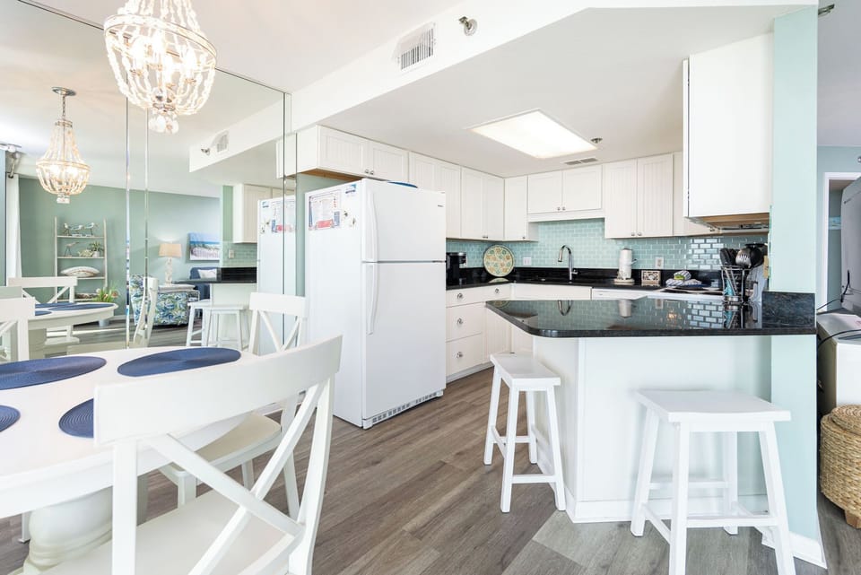 Gather around the round dining table, enjoying meals with a view of the inviting kitchen and vibrant decor