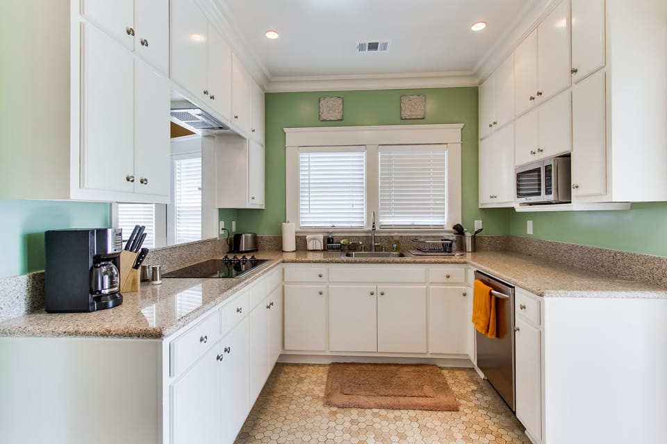 Discover the joys of cooking in the well-equipped kitchen featuring granite countertops and stainless steel appliances—an ideal space for culinary adventures.