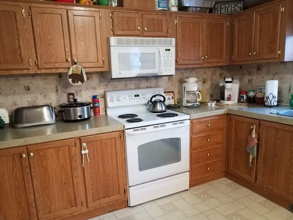 full cooks kitchen with many appliances such as crock pot, toaster, blender, ect