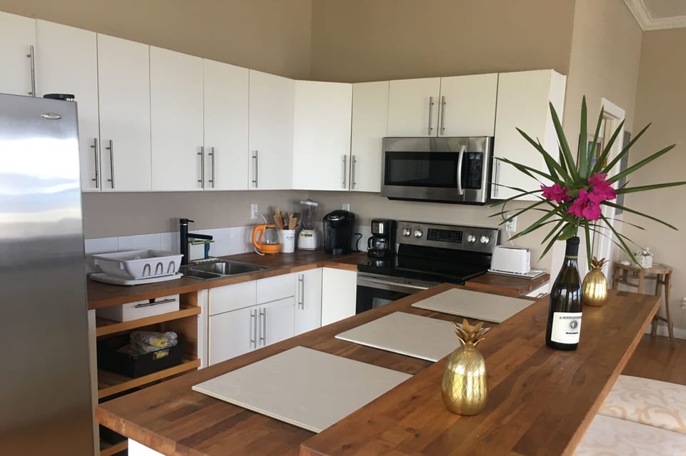 Well equipped kitchen with beautiful wooden countertops and bar seating