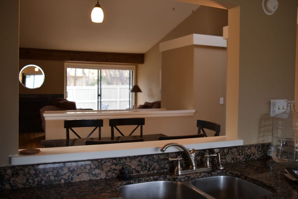 Kitchen views of dinning, living , fireplace and outdoor dinning .
