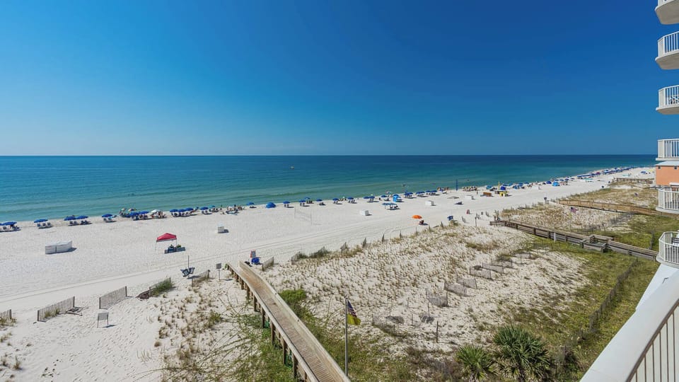 Enjoy the expansive views of the shoreline and inviting waters from your comfortable balcony seating