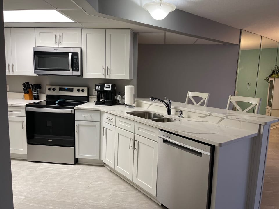 Fully renovated kitchen with stainless steal appliance and quartz counters. 