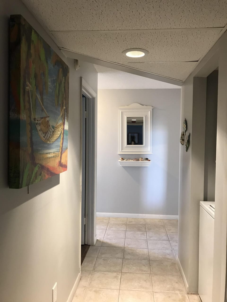 Hallway with private washer and dryer closet. 