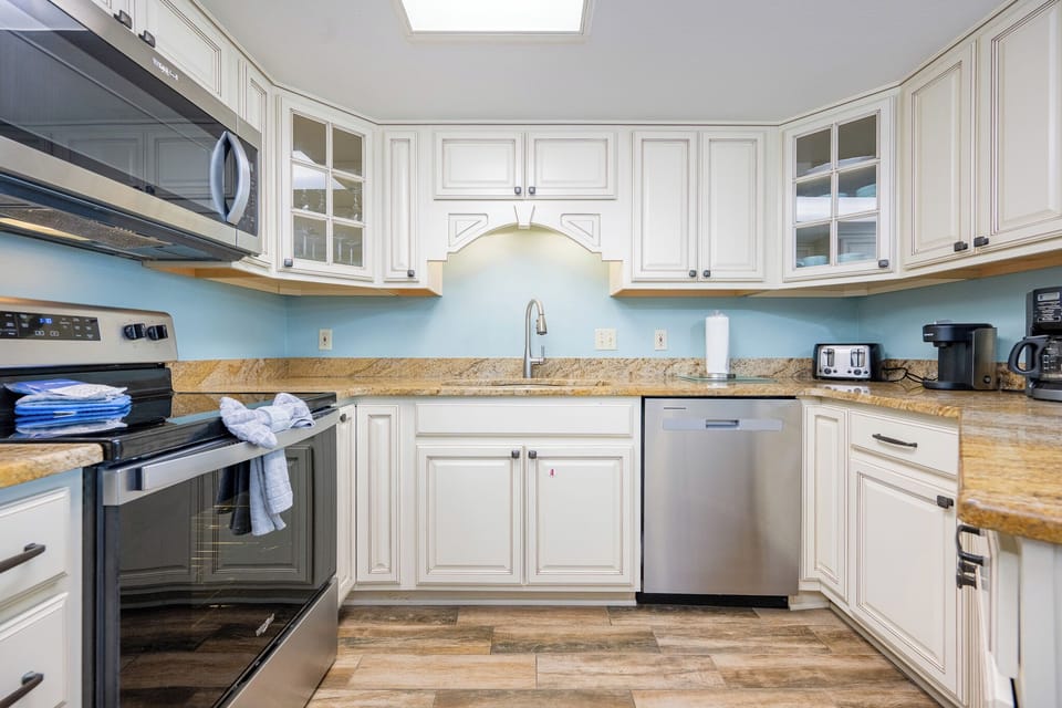 Enjoy preparing meals in this inviting kitchen, featuring stainless appliances and a breakfast bar
