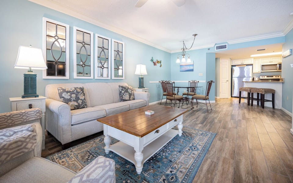 Relax in the inviting living area with a queen sofa sleeper, stylish decor, and a dining space for shared meals