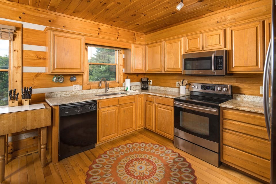 Well-equipped kitchen with granite countertops and stainless appliances
