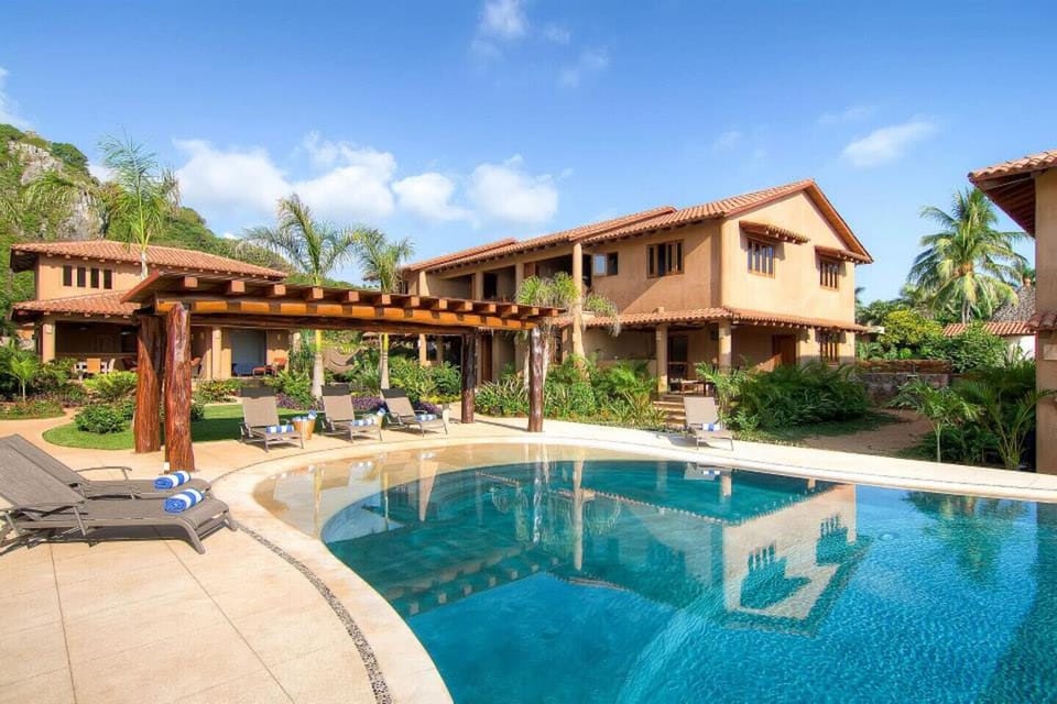 Infinity pool with villas behind