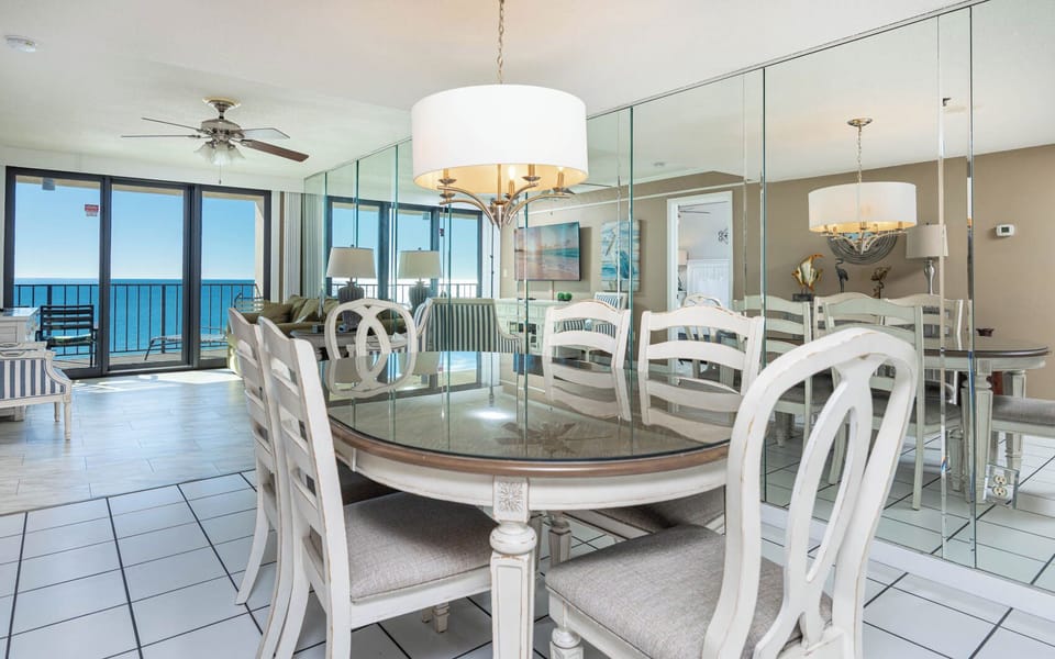 Gather around the dining table with loved ones while enjoying stunning views of the coast through expansive windows