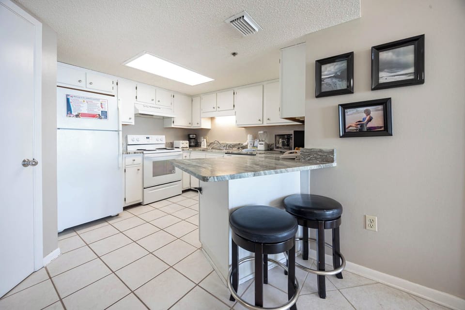 Gather around the inviting bar seating for casual meals in this bright kitchen with ample counter space
