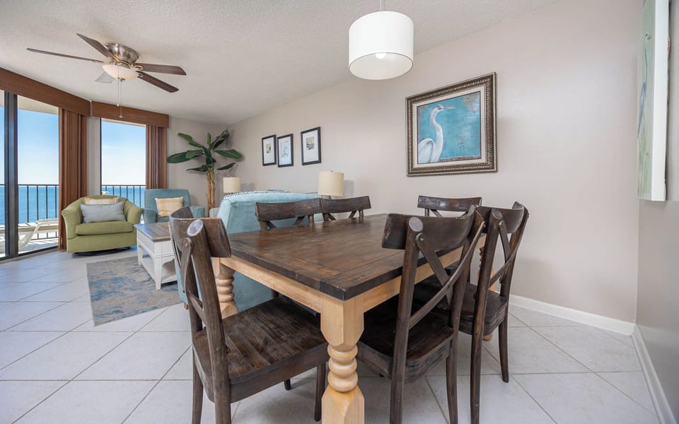 Enjoy meals at the rustic dining table, surrounded by inviting seating and coastal decor