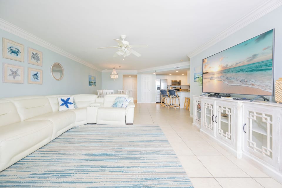 Kick back on the plush cream sofa while streaming your favorite shows in the cool living room ambiance