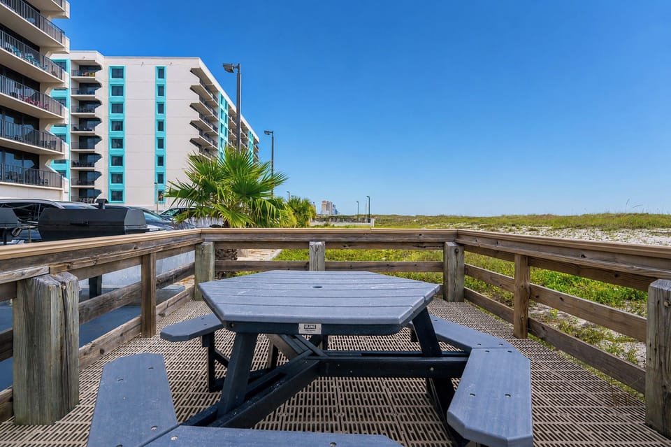 This inviting outdoor space is perfect for gathering with family and enjoying a meal in the coastal breeze