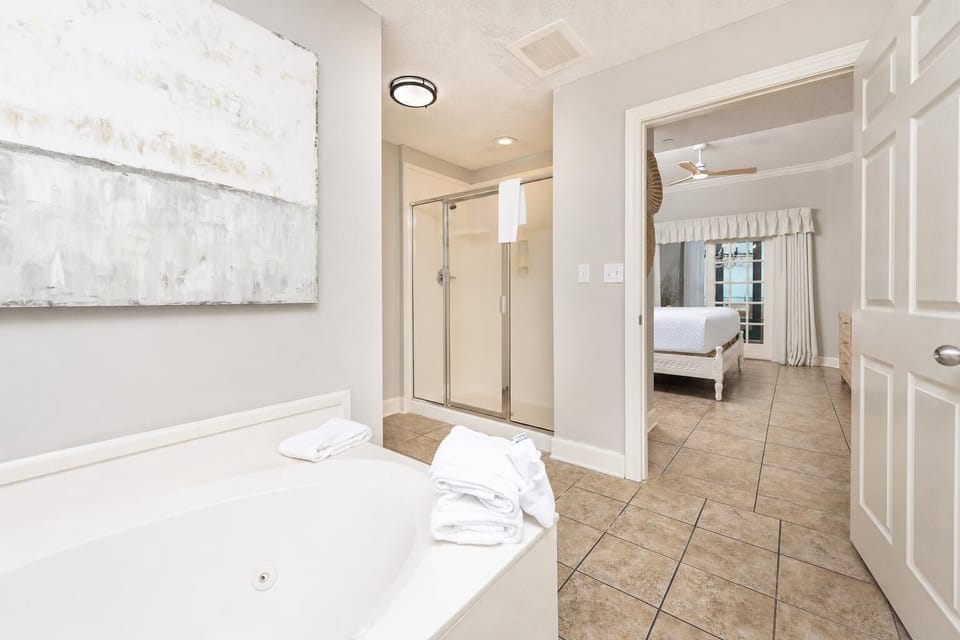 Refresh in the master bath after a day at the beach with a soothing jetted tub and relaxing walk-in shower