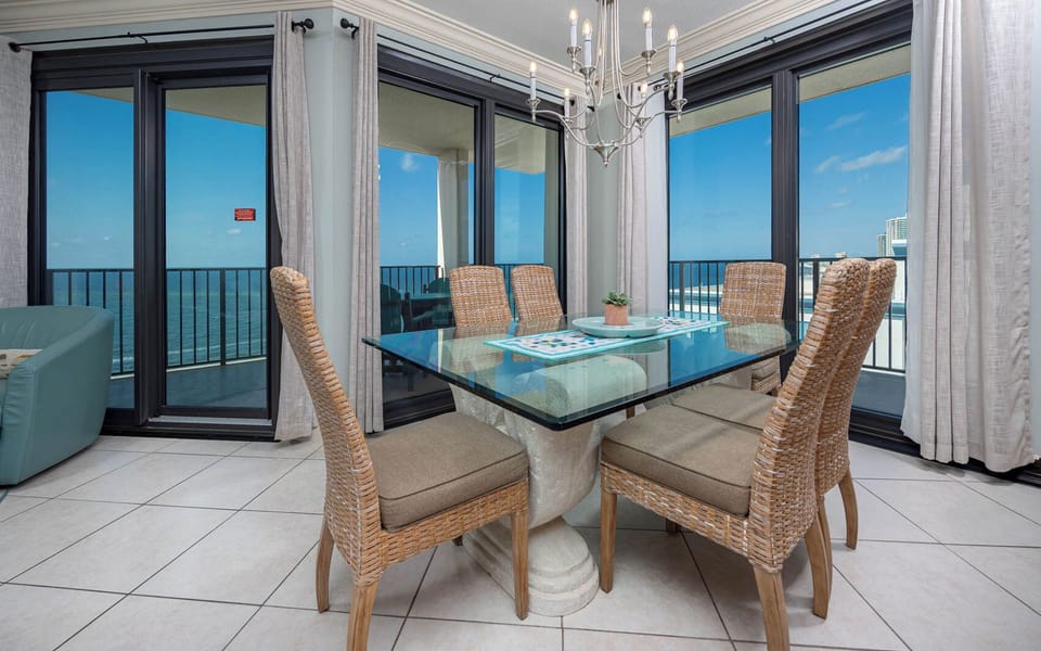 Dine at the glass table while enjoying refreshing beachfront views through large sliding doors