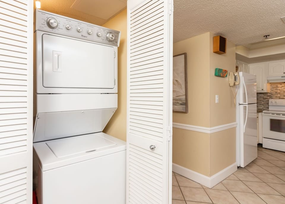 This laundry area features a stacked washer and dryer, providing convenience for your vacation needs