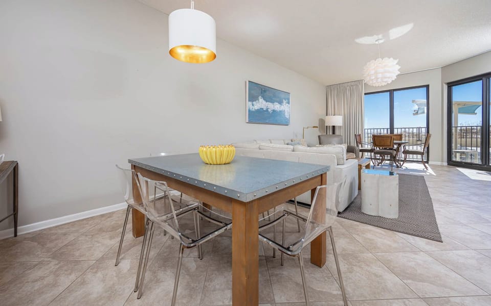 Gather around the sleek dining table, enjoying the airy space and views through large windows