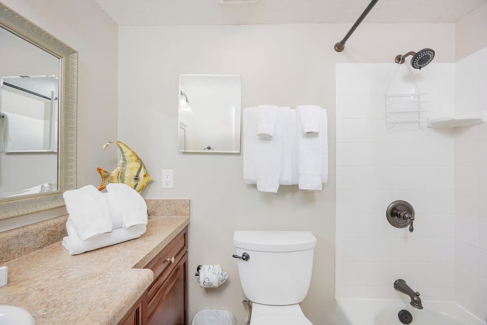 Rejuvenate in this guest bathroom, where fluffy towels await after a day of beach fun, inviting relaxation