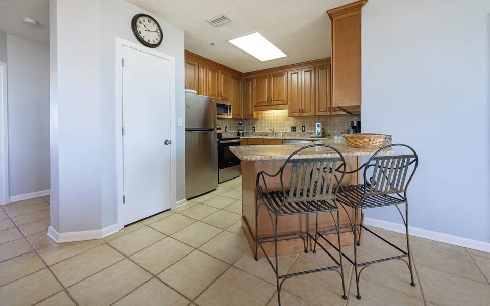 Granite breakfast bar with stylish seating, perfect for morning coffee or casual meals in this inviting kitchen
