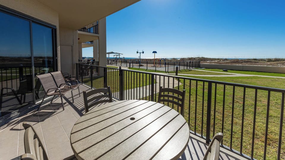 Enjoy meals or drinks at the round table on your balcony, with views of the grassy area and nearby splash park