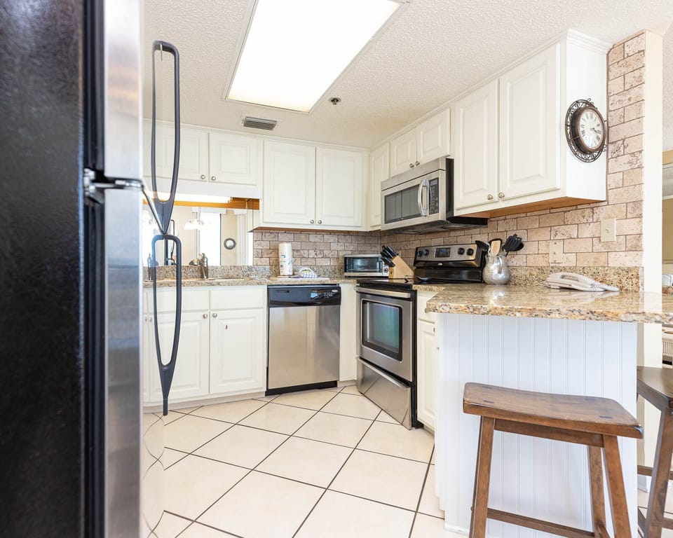 Prepare meals in the bright kitchen featuring granite countertops and stainless appliances