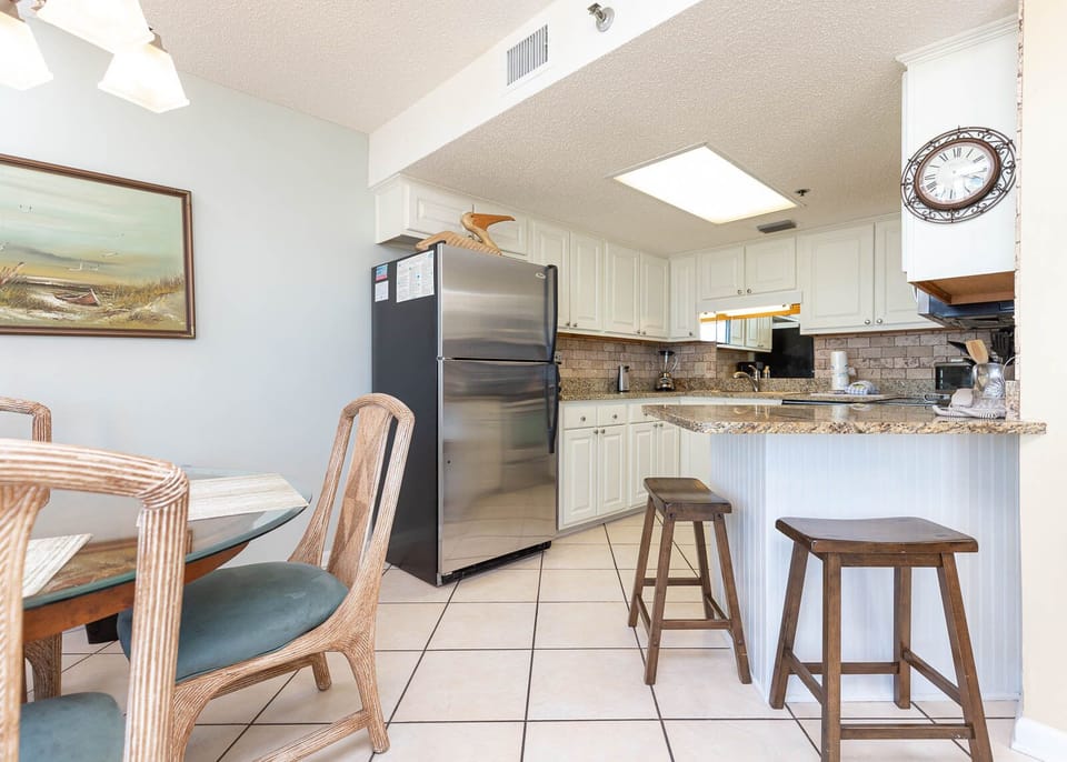 Enjoy meals at the round dining table, with a view of the stylish kitchen and the beach