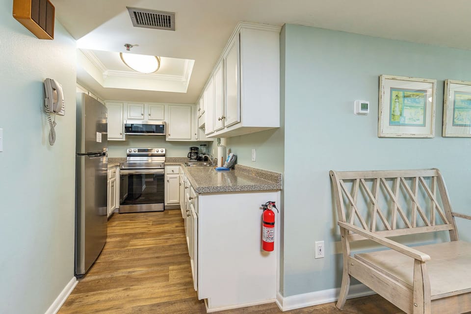 Embrace culinary creativity in a delightful kitchen with stainless appliances and convenient counter space