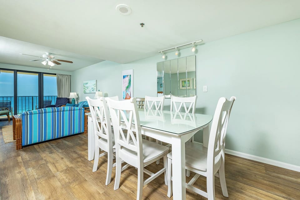 Gather your family around the dining table for games and laughter while enjoying stunning beach views