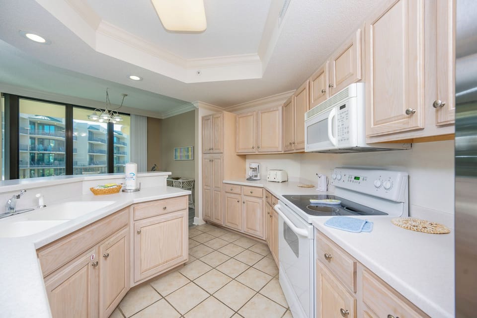 Experience the joy of preparing your favorite meals in a spacious kitchen while enjoying natural light