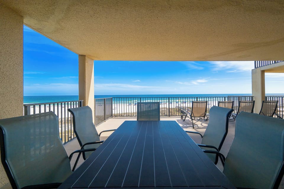 Extended balcony invites laughter and shared meals with loved ones framed by endless coastal views