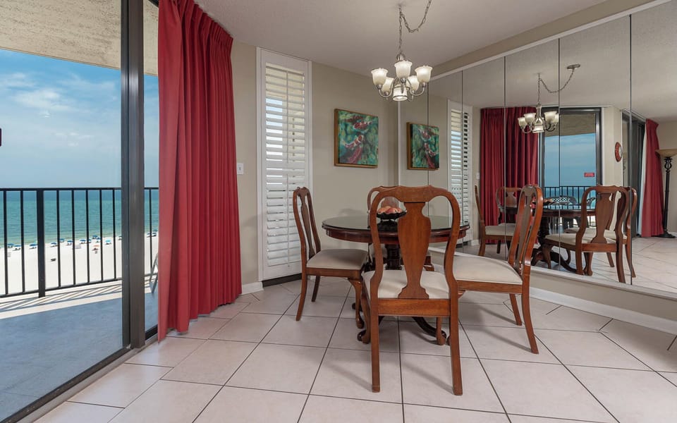 Dine at the elegant table surrounded by artful decor and enjoy the beach views from the balcony