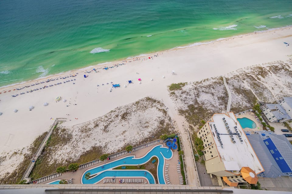 Gaze at the beautiful beach below from your balcony, discovering the pool and lazy river below