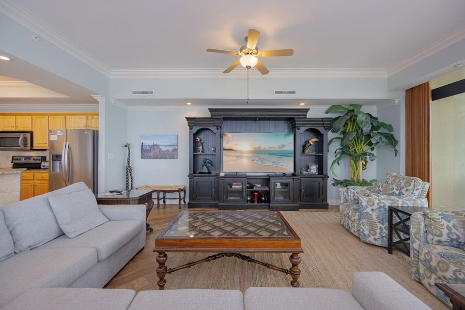 Experience family movie nights on the plush sectional, savoring the calming beach vibe in this inviting vacation retreat