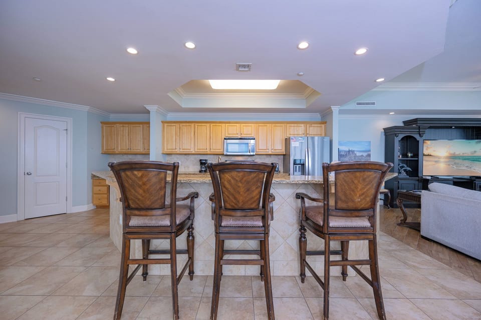 Enjoy mingling at the elegant kitchen island as you craft your favorite drinks while taking in the inviting beach vibe