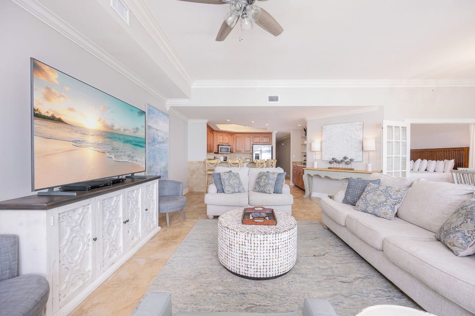 Living space featuring a large TV, stylish decor, and a cozy atmosphere perfect for relaxation