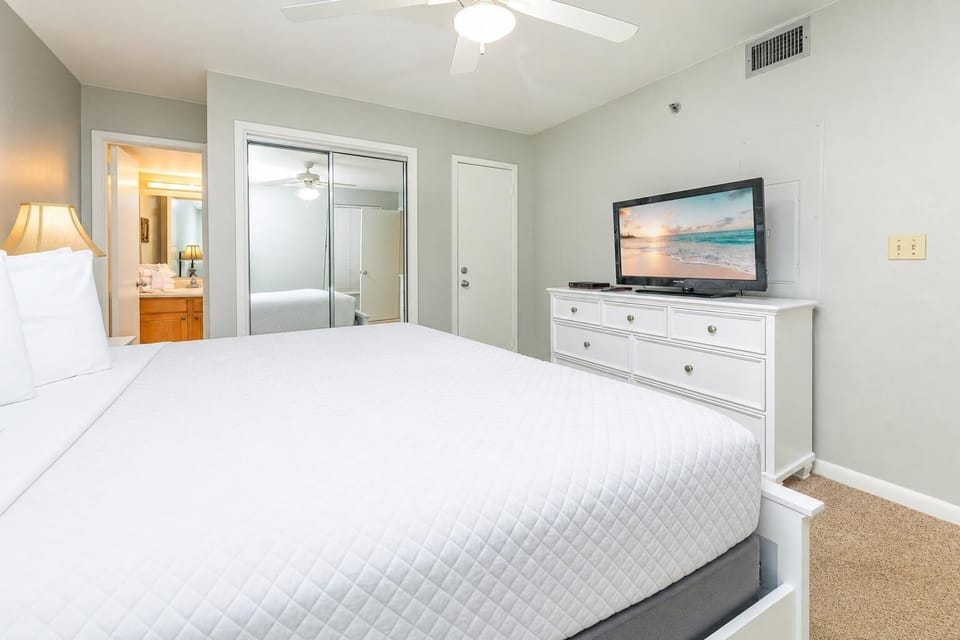 White dresser holds the TV where you stream favorite shows after unwinding in the king guest suite
