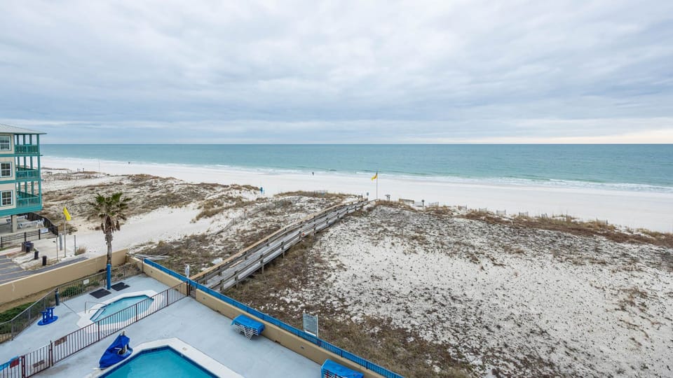 Gaze at the tranquil water and beach from your beachfront balcony, perfect for relaxation and enjoying the view