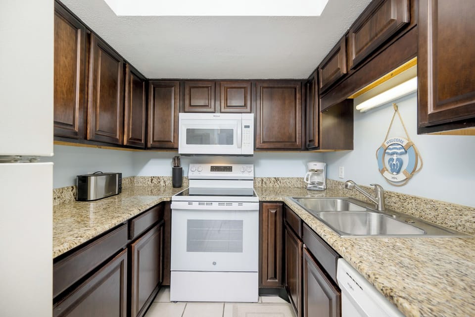 Prepare your favorite meals surrounded by rich cabinetry and enjoy the warmth of home while at the coast