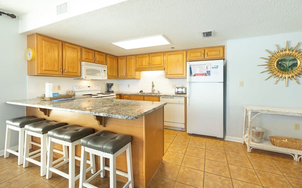 Gather around the cozy breakfast bar, savoring quality time as you prepare snacks or drinks for your beach adventures