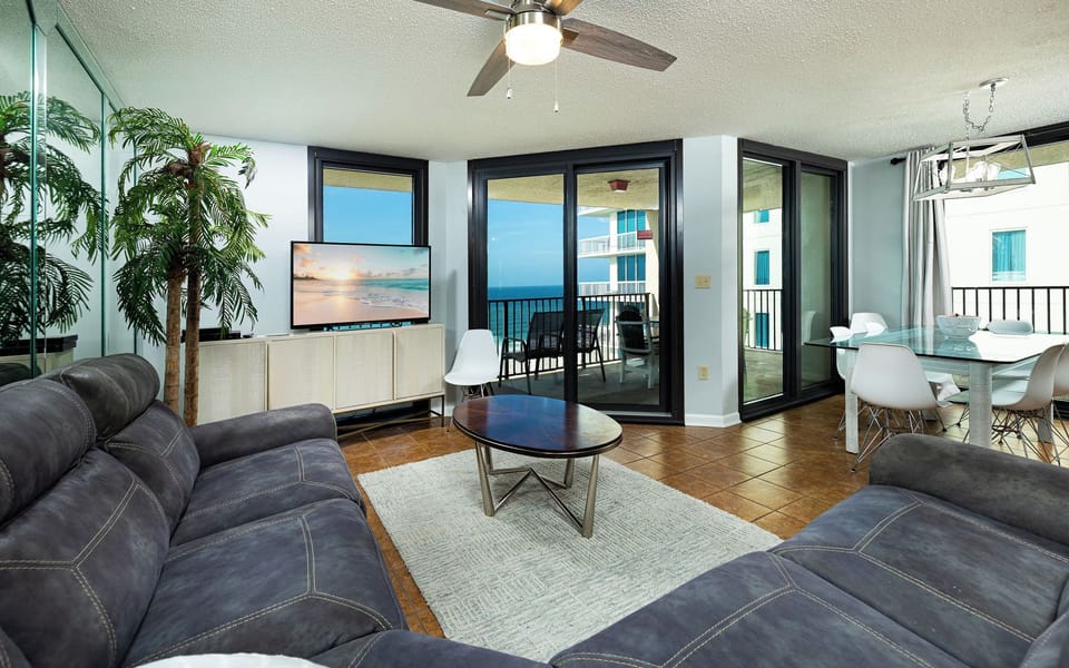 Unwind on the plush couch as you enjoy your favorite shows and the coastal vibe from your balcony