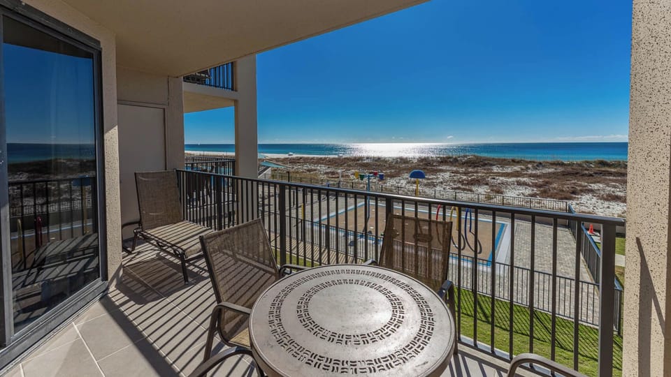 Relax on the balcony with a table and chairs, enjoying views of the shimmering water and splash pad below