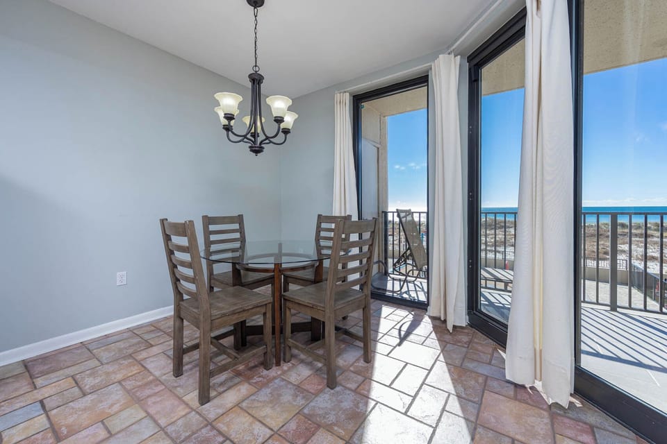 Dine at the glass-top table while enjoying views through expansive windows that invite natural light