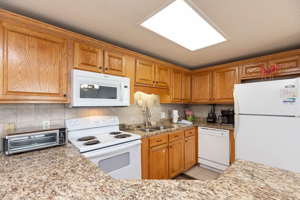 Cook and gather in this inviting kitchen with ample counter space and white appliances for your culinary adventures