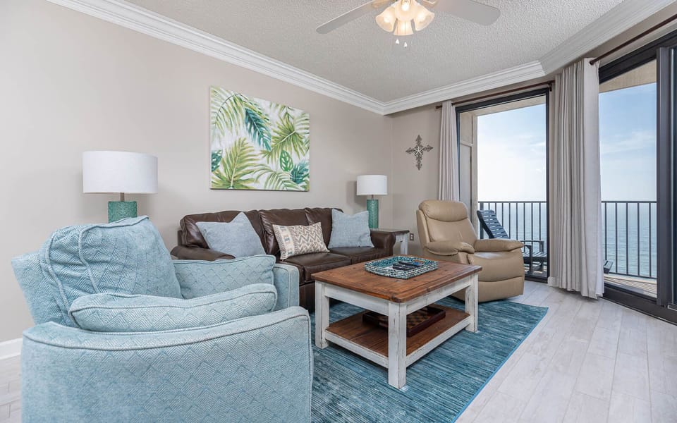 Relax in the inviting living area with a sofa with queen sleeper, a rustic coffee table, and beachfront views